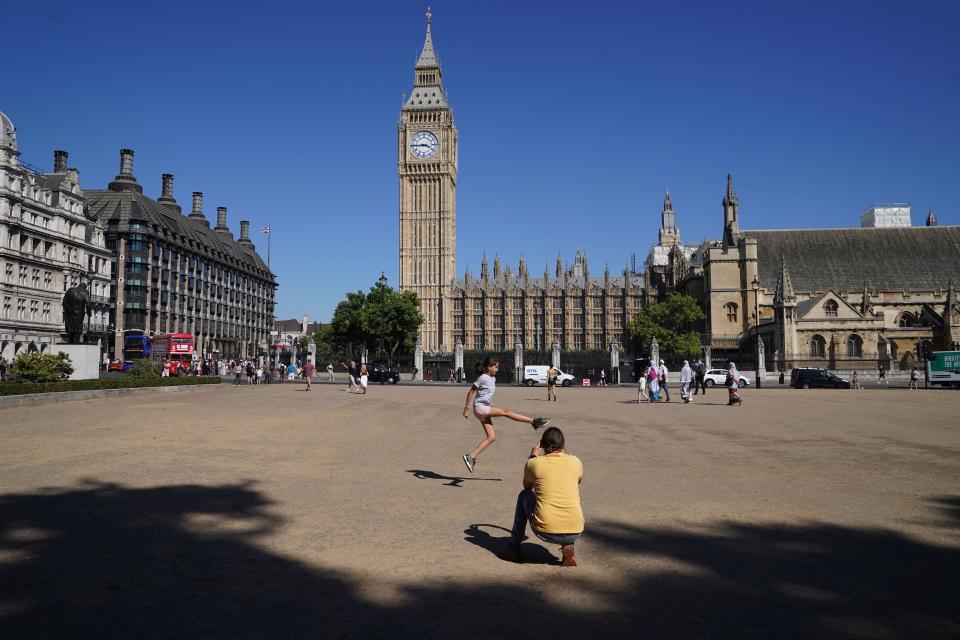 People on the dead grass in Parliament Square Garden, Westminster, central London (PA)