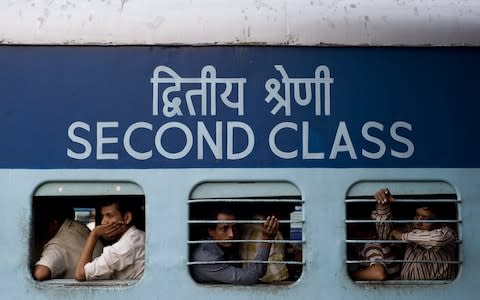 Indian commuters at a railway station in New Delhi - Credit: PEDRO UGARTE/AFP/Getty Images