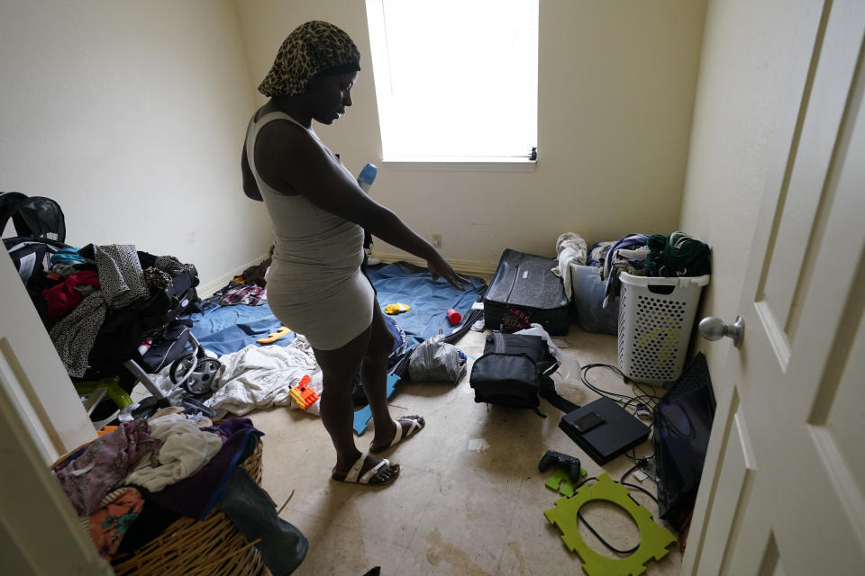 Toshia Patterson surveys her flooded apartment where water was about two-feet deep, in the aftermath of Hurricane Sally, Friday, Sept. 18, 2020, in Pensacola, Fla. (AP Photo/Gerald Herbert)