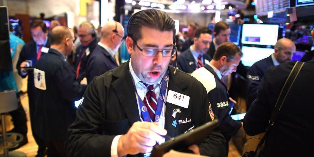 Traders work during the opening bell at the New York Stock Exchange (NYSE)