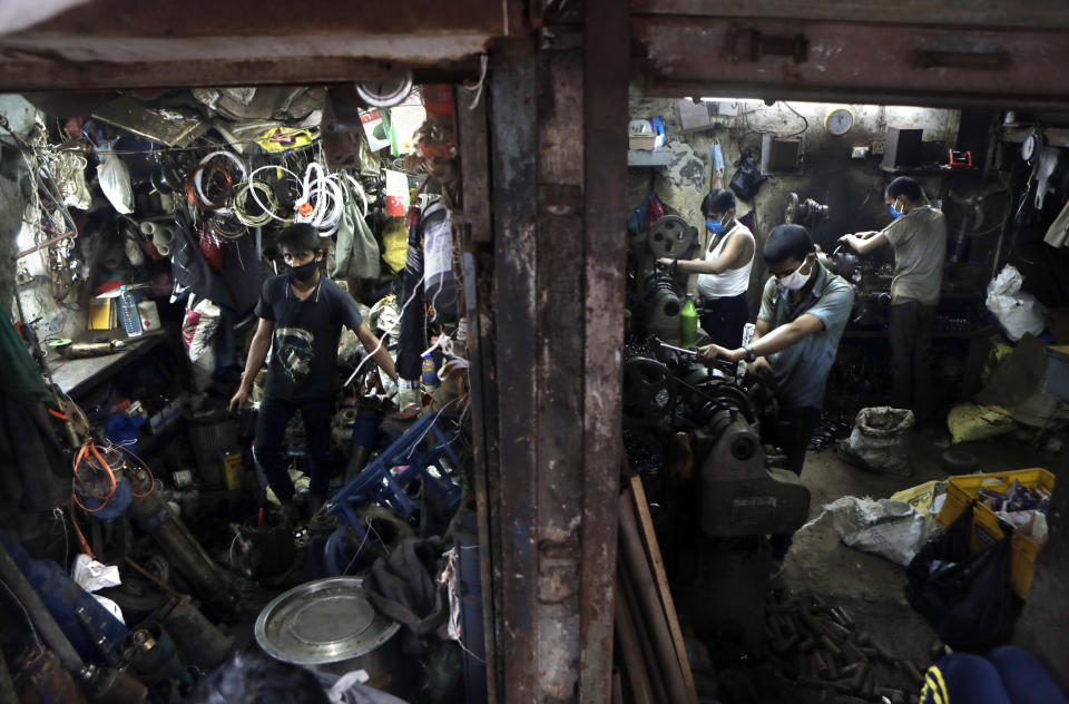 People work in a workshop at Dharavi, one of Asia's largest slums, in Mumbai, India, Friday, Sept. 25, 2020. Millions of distressed Indian manufacturers and traders are counting on the eagerly-awaited October-December festive season to rescue them from their coronavirus catastrophe. But spending may be the last thing on the minds of many Indians who have lost their jobs or businesses in the pandemic downturn. The government began easing a stringent two-month-long lockdown in June, but business is only a quarter to a fifth of usual and customers are scarce, said Praveen Khandelwal, general secretary of the Confederation of All India Traders. (AP Photo/Rajanish Kakade)