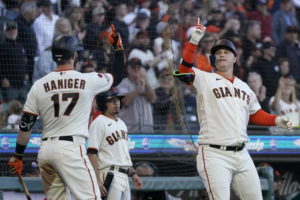 San Francisco Giants' Joc Pederson, right, celebrates with Mitch Haniger (17) after hitting a home run against the Colorado Rockies during the fifth inning of a baseball game in San Francisco, Sunday, Sept. 10, 2023. (AP Photo/Jeff Chiu)