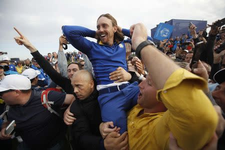 Golf - 2018 Ryder Cup at Le Golf National - Guyancourt, France - September 30, 2018. Team Europe's Tommy Fleetwood celebrates with spectators after winning the Ryder Cup REUTERS/Carl Recine