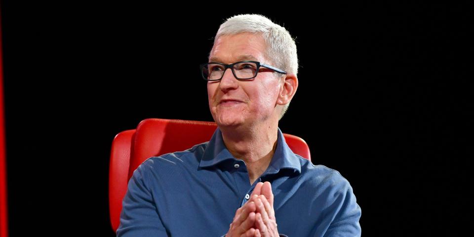 Tim Cook Apple sitting on a red chair