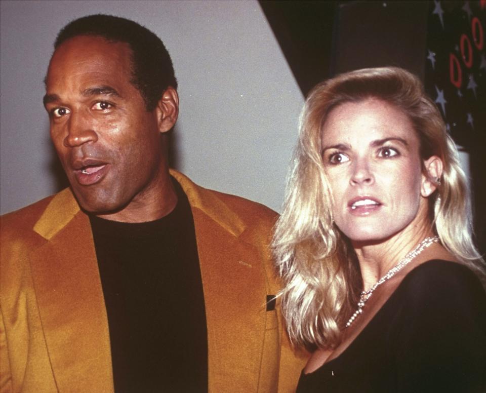 FILE - O.J. Simpson and his wife, Nicole Brown Simpson, arrive for the opening of the Harley-Davidson Cafe in New York on Oct. 19, 1993. Simpson, the decorated football superstar and Hollywood actor who was acquitted of charges he killed Nicole Brown Simpson and her friend but later found liable in a separate civil trial, has died. He was 76. (AP Photo/Paul Hurschmann, File)