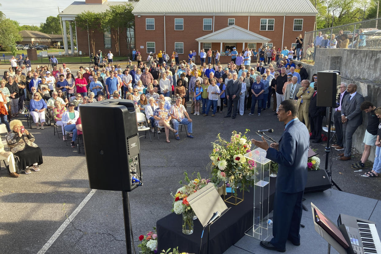 A pastor speaks at a prayer vigil outside First Baptist Church on Sunday, April 16, 2023, in Dadeville, Ala. Several people were killed and over two dozen were injured in a shooting at a teenager's birthday party in the town on Saturday, April 15. (AP Photo/Jeff Amy)