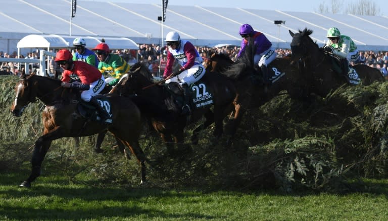 Jockey Derek Fox rides One for Arthur (C) over "The Chair" before going on to win the Grand National horse race at Aintree Racecourse in Liverpool, northern England on April 8, 2017