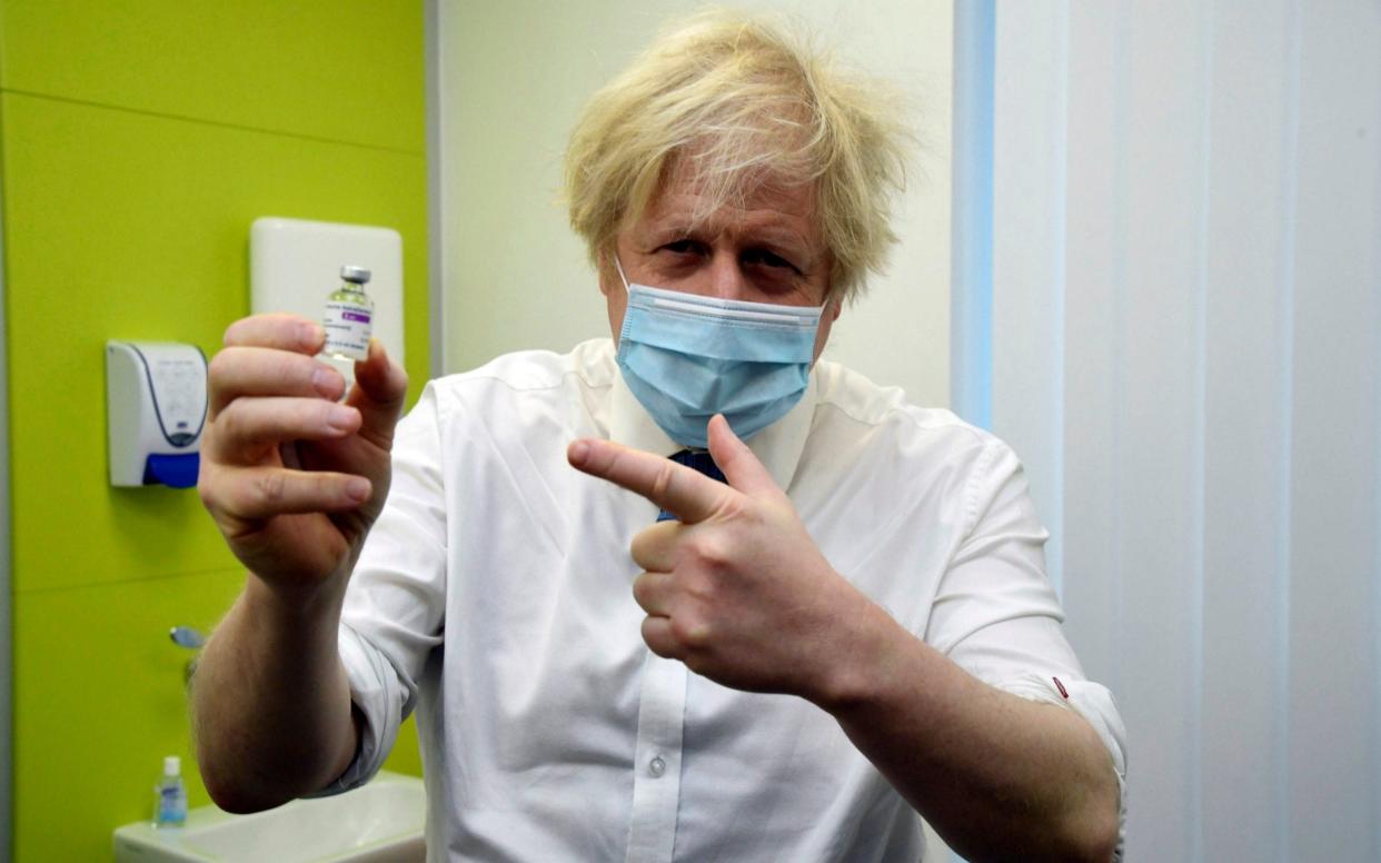 Boris Johnson holds a vial of the Oxford-AstraZeneca vaccine - AP/Jeremy Selwyn