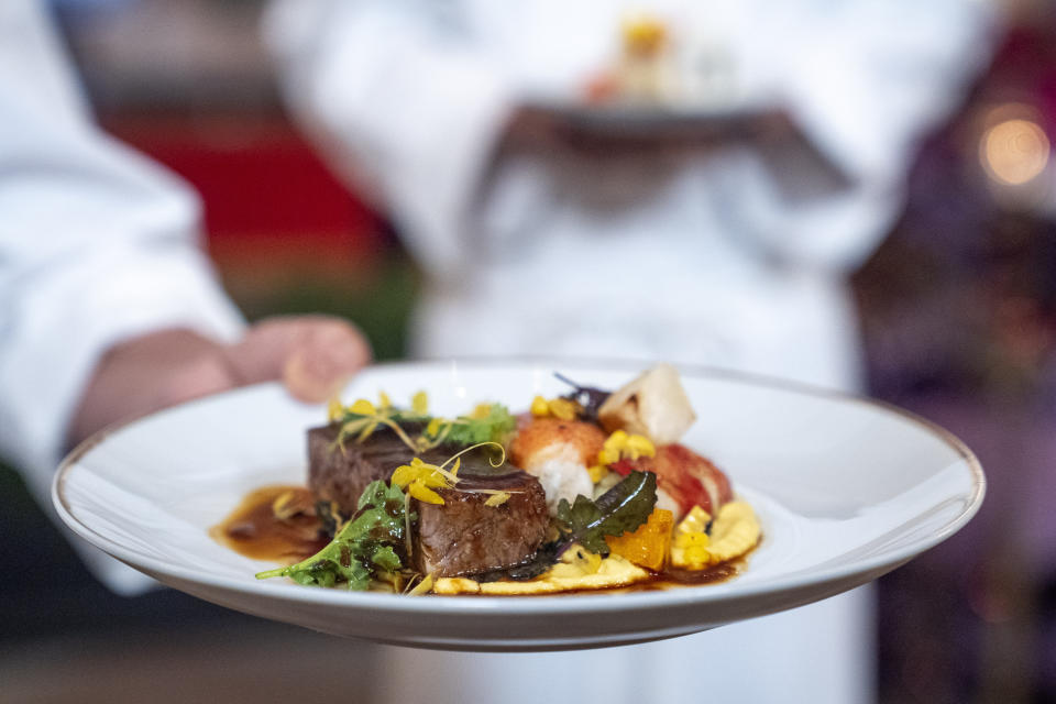 The main course of fruitwood-smoked beef short ribs, butter-poached lobster, citrus butter, baby kale, and a sweet corn purée is shown by White House Executive Chef Cris Comerford during a media preview, Wednesday, May 22, 2024, ahead of Thursday evening's State Dinner with with Kenya's President William Ruto, at the White House in Washington. (AP Photo/Jacquelyn Martin)