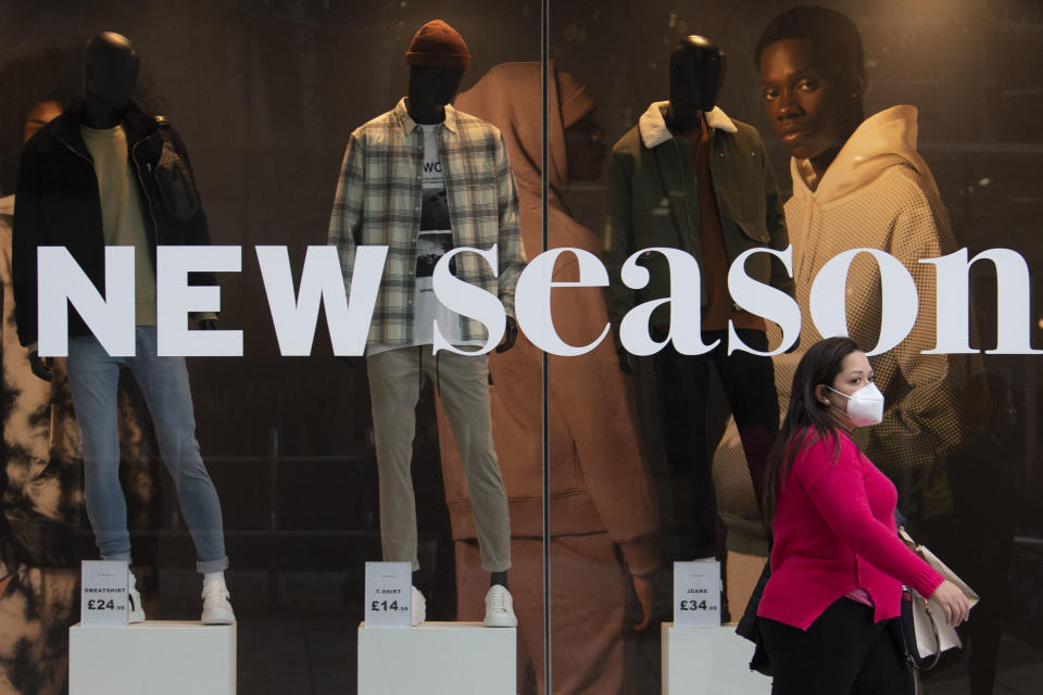 CARDIFF, WALES - OCTOBER 20: A woman wearing a face mask walks past a Topshop store on October 20, 2020 in Cardiff, Wales. Wales will go into a national lockdown from Friday until November 9. People will be told to stay at home and pubs, restaurants, hotels and non-essential shops must shut. Primary schools will reopen after the half-term break, but only Years 7 and 8 in secondary schools can return at that time under new "firebreak" rules. Gatherings indoors and outdoors with people not in your household will also be banned. (Photo by Matthew Horwood/Getty Images)