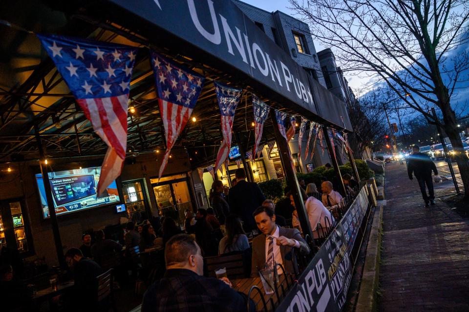 Patrons of the Union Pub wait for the results of the "Super Tuesday" Democratic Party primaries on Capitol Hill next to the US Congress in Washington on March 3, 2020. - Eyes glued to the continuous news coverage, the customers of this Washington bar close to the Capitol, parliamentary assistants, consultants or lobbyists often addicted to politics, make "Super Tuesday" a mix of cocktails, fried food and election results. (Photo by Eric BARADAT / AFP) (Photo by ERIC BARADAT/AFP via Getty Images)