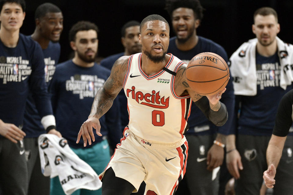 Portland Trail Blazers guard Damian Lillard (0) brings the ball up court during the first half of the team's NBA basketball game against the Memphis Grizzlies on Wednesday, Feb. 12, 2020, in Memphis, Tenn. (AP Photo/Brandon Dill)