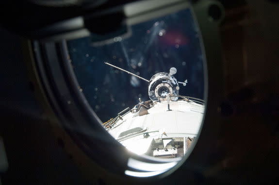 The Progress M-19M (51P) Russian cargo craft is seen through a window arriving at the International Space Station in April 2013. It departed on June 11 packed with trash, including the station's first treadmill, destined to be destroyed during