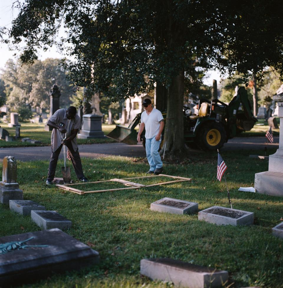 Ronnie King (left) begins the process of digging a grave at the Walnut Hills Cemetery in September.