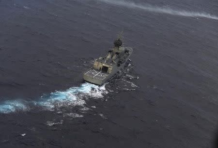 The Royal Australian Navy ship HMAS Perth is guided into position by a Royal New Zealand Airforce (RNZAF) P-3K2 Orion aircraft to recover an object in the southern Indian Ocean, as the search continues for missing Malaysia Airlines flight MH370 April 13, 2014. REUTERS/Greg Wood/Pool