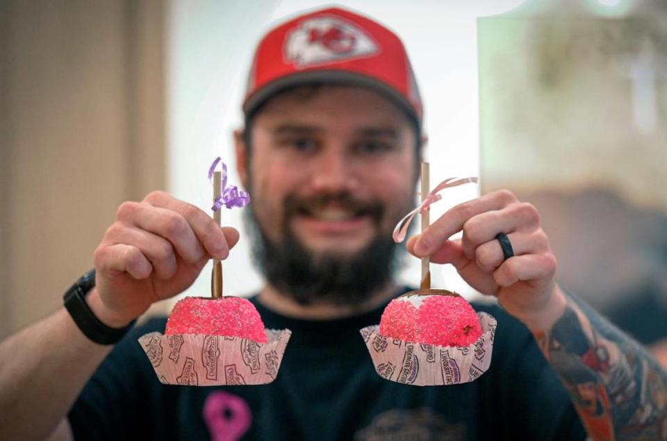 Matt Geehan, owner of Rocky Mountain Chocolate Factory at Union Station, display two of the pink Sprinkles Apples, he is selling to Barbie fans visiting Union Station.. Geehan said pink sprinkles have become quite costly for him to purchase since the Barbie movie craze began. Tammy Ljungblad/tljungblad@kcstar.com