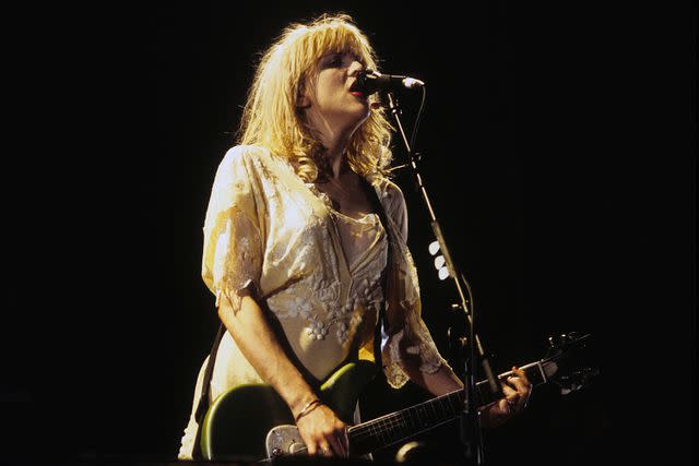 <p>Jim Steinfeldt/Michael Ochs Archives/Getty Images</p> Courtney Love with her band Hole performs in St. Paul, Minnesota in September 1994