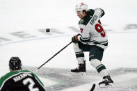 Minnesota Wild left wing Kirill Kaprizov (97) skates for the puck in front of Dallas Stars defenseman Jani Hakanpaa (2) during the second period of an NHL hockey game in Dallas, Sunday, Dec. 4, 2022. (AP Photo/LM Otero)