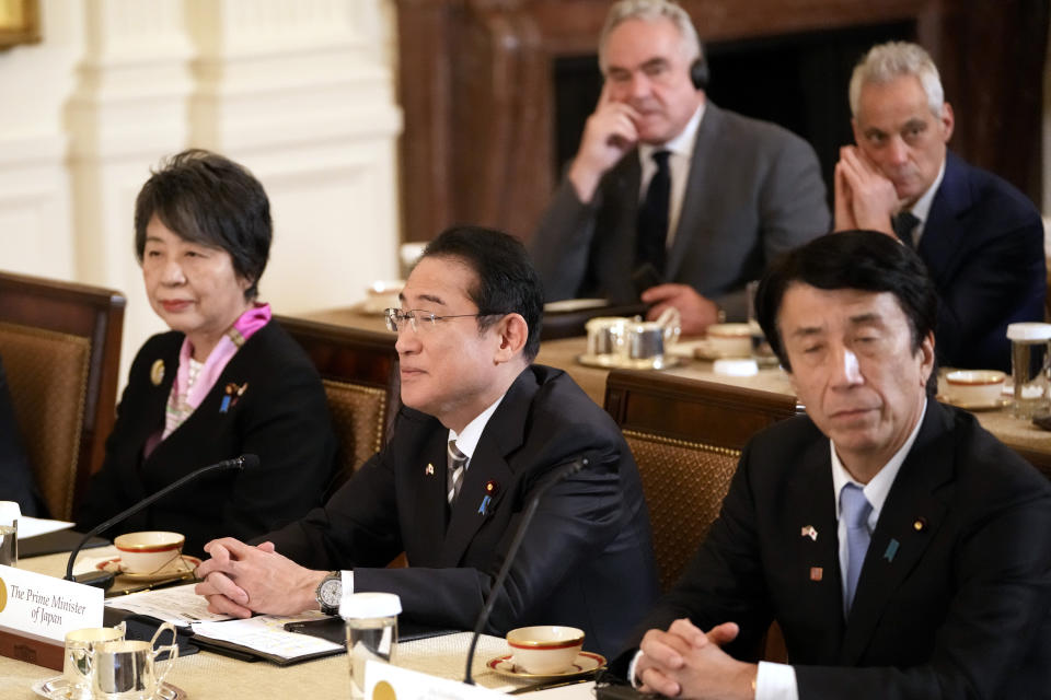 Japanese Prime Minister Fumio Kishida, second left, and U.S. Ambassador to Japan Rahm Emanuel, in background at right, attend a trilateral meeting with President Joe Biden and Philippine President Ferdinand Marcos Jr., not pictured, in the East Room of the White House in Washington, Thursday, April 11, 2024. (AP Photo/Mark Schiefelbein)