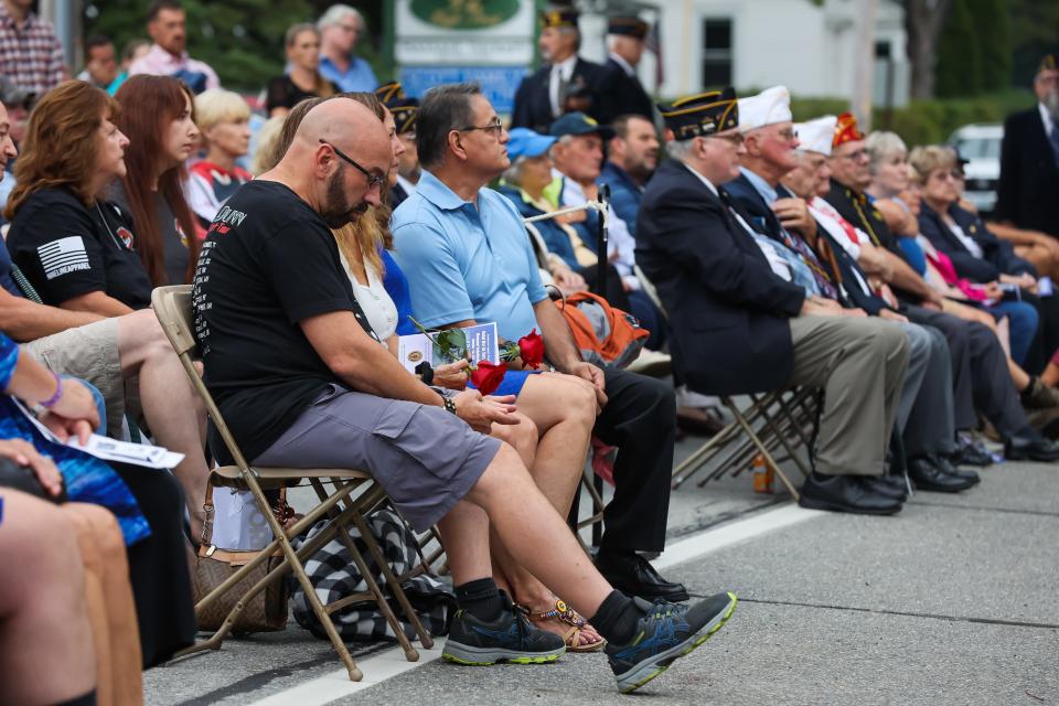 The family of fallen NH soldier, SPC Brandon T. Martinez, looks on as Gov. Chirs Sununu talks about the sacrifices made to keep America safe during the  American Legion Post 35 Global War On Terrorism Monument rededication Sunday, Sept. 11, 2022 in Hampton.