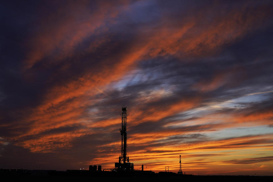 FILE - Oil drilling rigs are pictured at sunset, Monday, March 7, 2022, in El Reno, Okla. On Friday, May 5, The Associated Press reported on stories circulating online incorrectly claiming the planet has an unlimited supply of oil. (AP Photo/Sue Ogrocki, File)