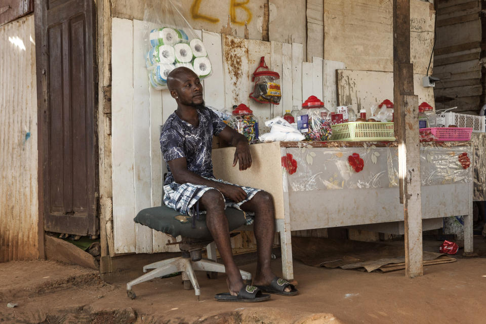 A man waits for customers in his shop in the slum district of Mont Baduel, in Cayenne, French Guiana, Friday, July 10, 2020. France's most worrisome virus hotspot is in fact on the border with Brazil - in French Guiana, a former colony where health care is scarce and poverty is rampant. The pandemic is exposing deep economic and racial inequality in French Guiana that residents say the mainland has long chosen to ignore. (AP Photo/Pierre Olivier Jay)
