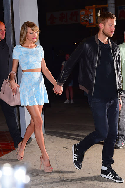 Taylor Swift and Calvin Harris are still going strong! The statuesque couple enjoyed a date night on Tuesday in New York City, going for pizza at L'asso restaurant in Little Italy. The 25-year-old "Bad Blood" singer showed off her slim stomach in a baby blue matching crop top and skirt ensemble by Aqua, and put her long legs on display in sky-high nude stilettos. For his part, Calvin kept it cool in jeans and a black leather jacket, sporting Adidas sneakers. <strong> PHOTOS: All of Taylor Swift's Hot Boyfriends, Past and Present </strong> 247PapsTV Clearly, the pair is still in the honeymoon phase of their relationship. "They were laughing and talking and Calvin was kissing her hand," an eyewitness tells ET about their hour-and-a-half pizza date. The 31-year-old DJ/producer was also spotted going back to Taylor's pad with his luggage, presumably staying at her place for the night. 247PapsTV <strong>WATCH: Taylor Swift and Calvin Harris Make a Hot Couple During Romantic Date Night</strong> Taylor's new beau certainly seems to be the real deal as opposed to a summer romance -- and seriously, when are these two <em>not</em> holding hands? Check out the video below to see Taylor and Calvin showing their favorite type of PDA earlier this month on another romantic date night, this time in Santa Monica, Calif.