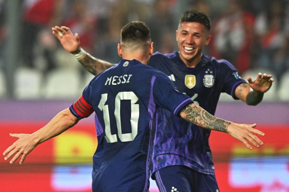 Lionel Messi celebrates with teammate Enzo Fernandez after scoring against Peru.