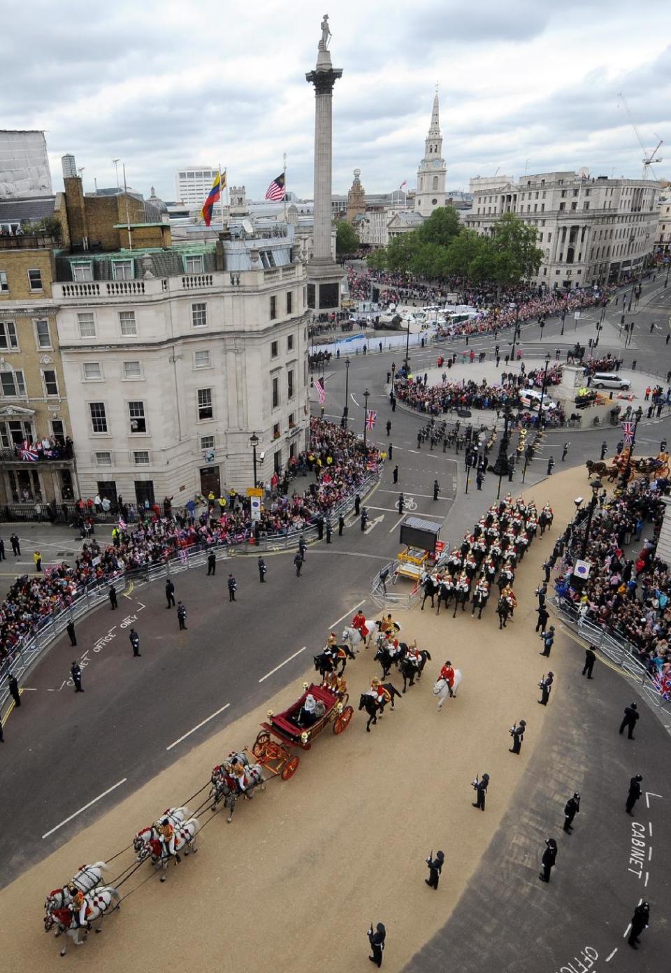 Britain's Queen Elizabeth II, Prince Charles and Camilla Duchess of Cornwall, travel in a carriage through Trafalgar Square, London on route to Buckingham Palace during the Diamond Jubilee celebrations. Tuesday June 5, 2012. Nelson's Column is seen in the background. (AP Photo/Anthony Devlin/Pool)