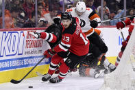 New Jersey Devils' Nico Hischier (13) plays the puck during the second period of an NHL hockey game against the Philadelphia Flyers, Saturday, April 13, 2024, in Philadelphia. (AP Photo/Derik Hamilton)