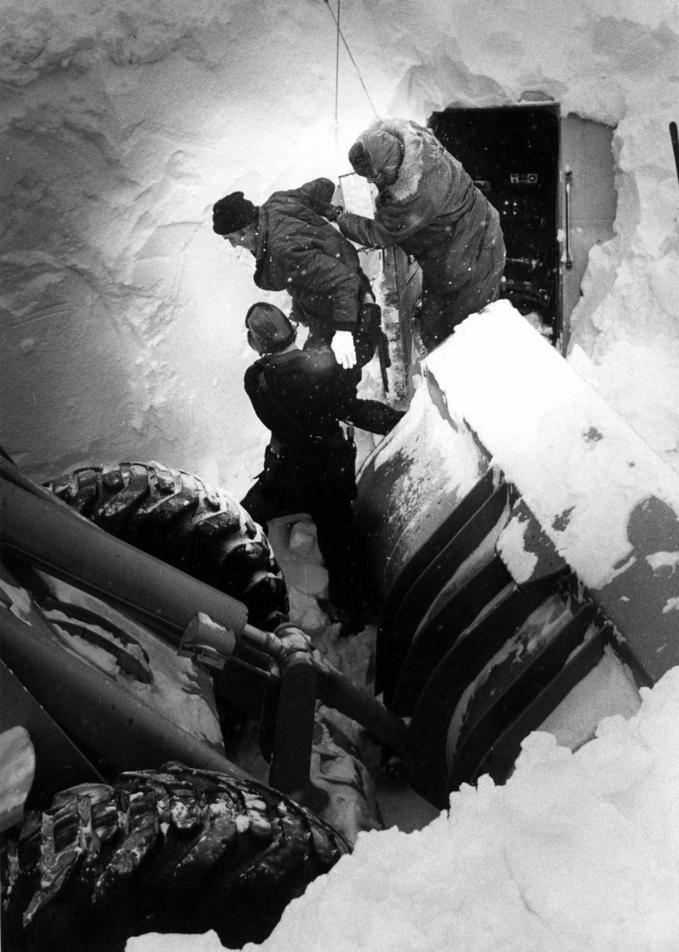 Truck driver James Truly is helped from the cab of his rig after spending most of five days buried in the truck beneath a huge snowdrift in Mansfield, Ohio, Jan. 31, 1978. Truly stopped his semi-tractor trailer along Ohio Route 13 north of Mansfield during a massive blizzard. The storm raged for several days and snow completely covered the big rig. No one knew for a couple of days that Truly and his truck were in the drift. He was finally discovered on Jan. 31 when Ohio Air National Guard personnel were opening the state highway with a big snowblower.