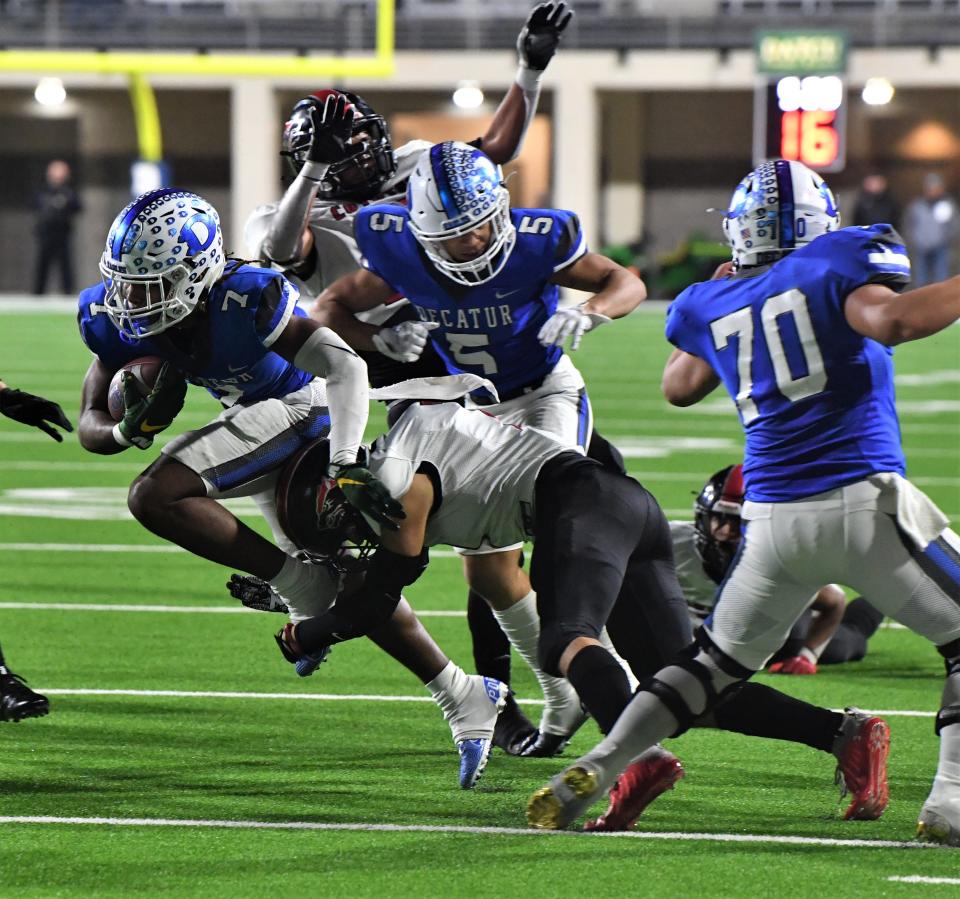 Decatur's Nate Palmer (7) jumps past Wichita Falls High's Guy Izaguirre during the state quarterfinals in Denton on Friday, December 2, 2022.