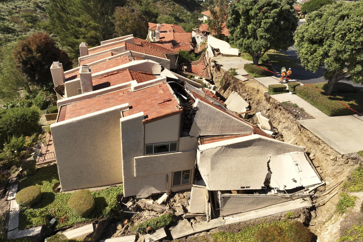 This photo shot with a drone shows damage from earth movement to a property in Rolling Hills Estates, Calif., Monday, July 10, 2023. The homes in the Los Angeles County city of Rolling Hills Estates were hastily evacuated by firefighters Saturday when cracks began appearing in structures and the ground. (Ted Soqui via AP)