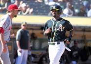 Sep 20, 2018; Oakland, CA, USA; Oakland Athletics shortstop Marcus Semien (10) scores a run against Los Angeles Angels starting pitcher Deck McGuire (68) during the sixth inning at Oakland Coliseum. Mandatory Credit: Kelley L Cox-USA TODAY Sports