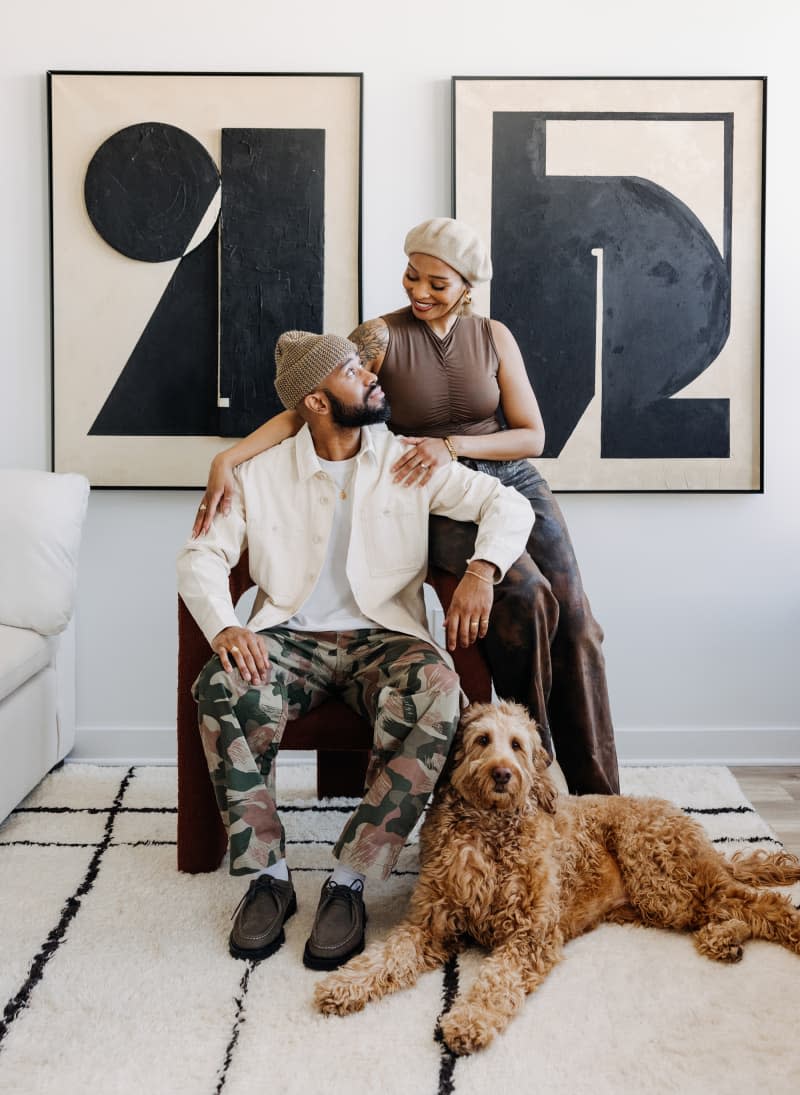 Couple with their dog on chair in living room