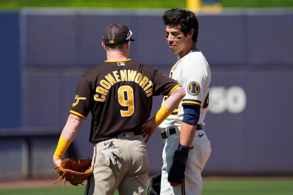 San Diego Padres second baseman Jake Cronenworth (9) and Milwaukee Brewers left fielder Christian Yelich (22) chat in the second inning during a spring training game March 23 at American Family Fields of Phoenix.