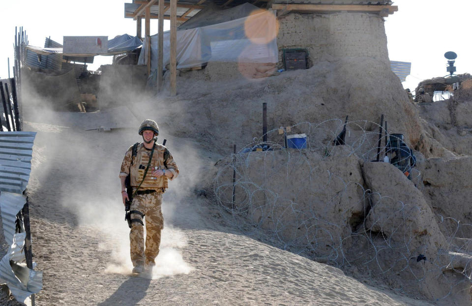 FILE In this Jan. 2, 2008 file photo, Britain's Prince Harry on patrol through the deserted town of Garmisir close to FOB (forward operating base) Delhi, where he was posted in Helmand province Southern Afghanistan. Princess Diana’s little boy the devil-may-care red-haired prince with the charming smile is about to become a father. The arrival of the first child for Prince Harry and his wife Meghan will complete the transformation of Harry from troubled teen to family man, from source of concern to source of national pride. (John Stillwell, Pool Photo via AP, File)