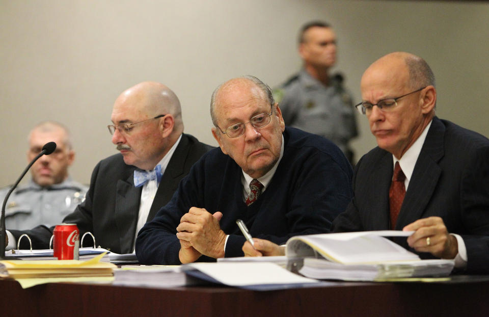 Former Tampa Police captain Curtis Reeves, Jr., center, sits beside his defense attorneys Richard Escobar, right, and Dino Michaels as they listen to his taped interview by detectives during his bond reduction hearing before Circuit Judge Pat Siracusa at the Robert D. Sumner Judicial Center in Dade City Friday, Feb. 7, 2014. Reeves is suspected of fatally shooting Chad Oulson, 43, and wounding his wife, Nicole, 33, during an argument Jan. 13 over texting at the Cobb Grove 16 theater in Wesley Chapel, Fla. (AP Photo/Pool Tampa Bay Times, Brendan Fitterer, Pool)