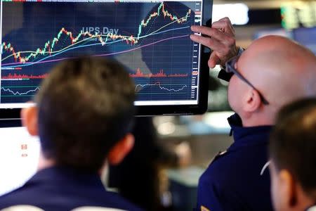 Traders work on the floor of the New York Stock Exchange (NYSE) shortly after the opening bell in New York, U.S., January 31, 2017. REUTERS/Lucas Jackson