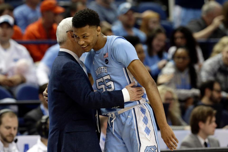 North Carolina head coach Roy Williams hugs North Carolina guard Christian Keeling (55) during the second half of an NCAA college basketball game against Virginia Tech at the Atlantic Coast Conference tournament in Greensboro, N.C., Tuesday, March 10, 2020. (AP Photo/Gerry Broome)