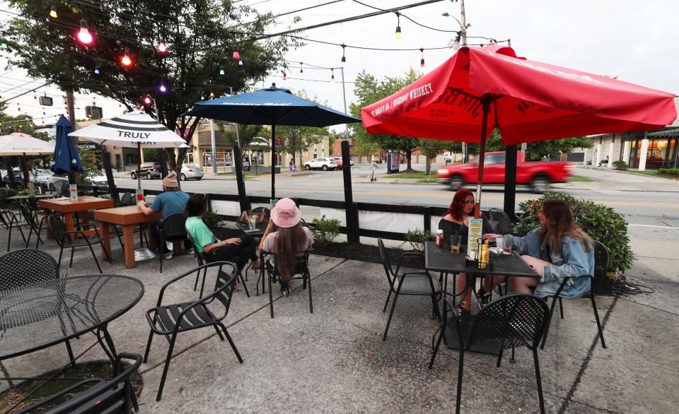 Guests enjoy drinks on the patio outside the Highlands Tap Room on  Bardstown Road in Louisville, Ky. on Sep. 20, 2021.  There is a proposal to close off this stretch of road to vehicles on the weekend.