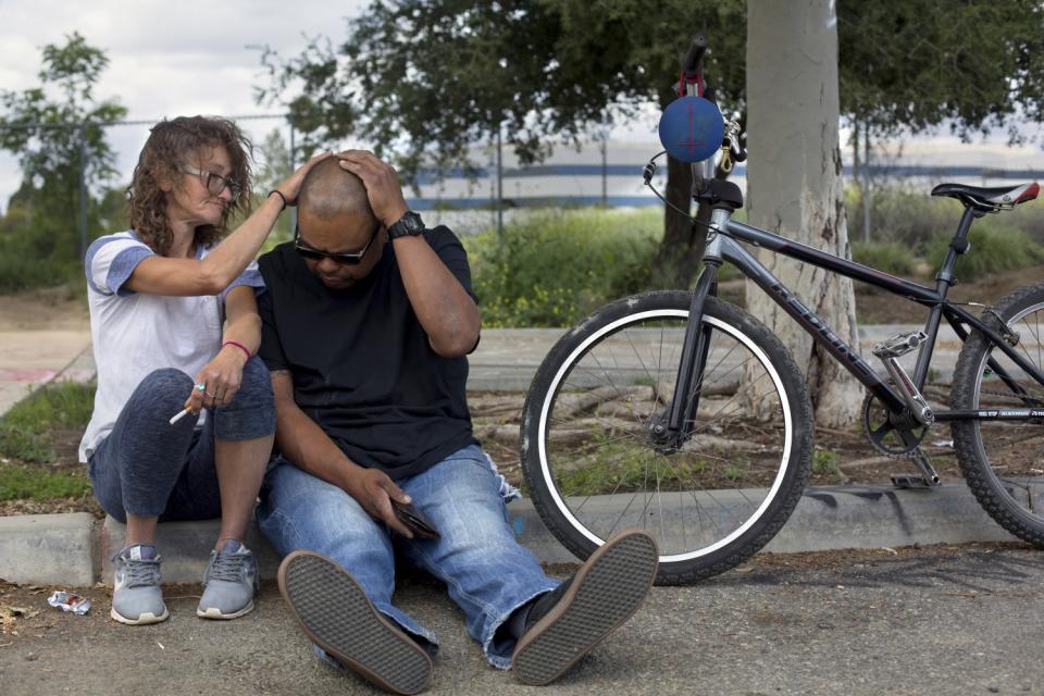 Pablo "Paul" Mawyin is comforted by girlfriend Elizabeth Bolton as she prepared to leave the Encino encampment in 2019