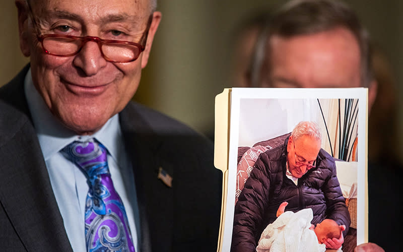 Majority Leader Chuck Schumer (D-N.Y.) shows a picture of his newly born grandson