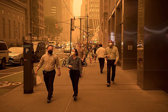 <p>Michael Nagle/Xinhua/Eyevine/Redux</p> Pedestrians wearing face masks in New York in June as smoke from Canada triggered air quality alerts
