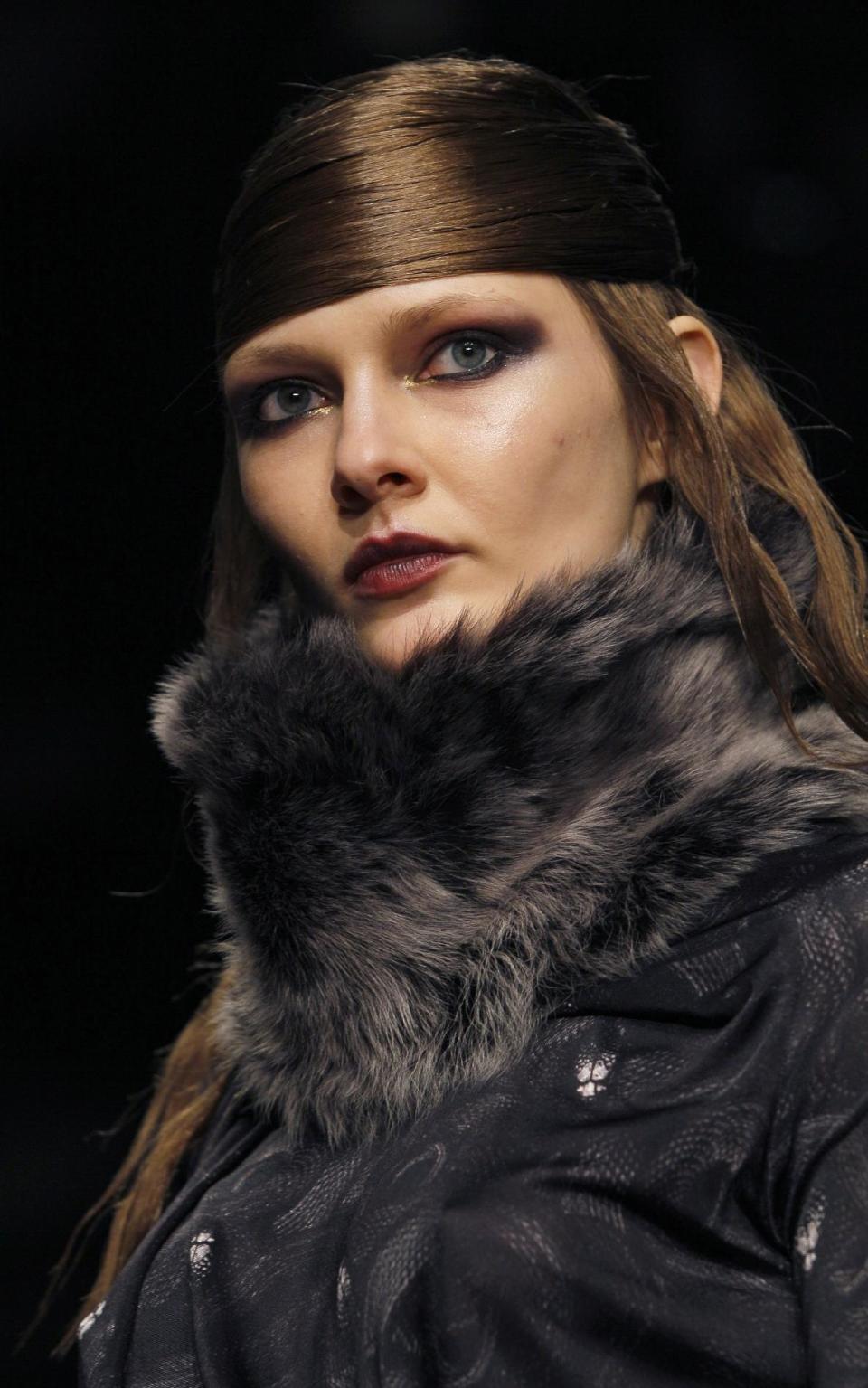 A model displays a creation by designer Aminaka Wilmont during a fashion show at London Fashion Week, Tuesday, Feb. 21, 2012. (AP Photo/Kirsty Wigglesworth)