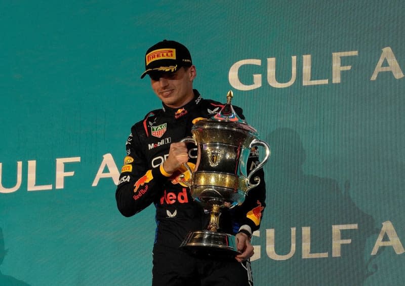 Dutch Formula 1 driver Max Verstappen of the Oracle Red Bull team celebrates on the podium with the trophy after winning the Bahrain Grand Prix at the Bahrain International Circuit. Hasan Bratic/dpa