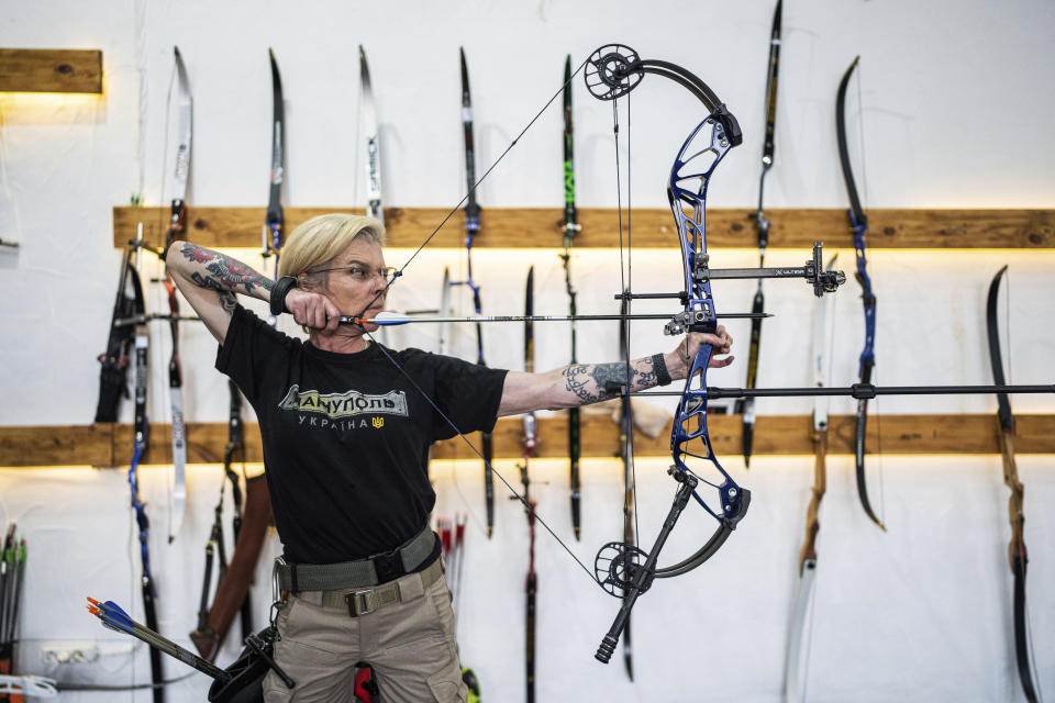 Ukrainian medic Yuliia Paievska, known as Taira, shoots a bow during the archery training in Kyiv, Ukraine, on Friday, July 8, 2022. The celebrated Ukrainian medic who was held captive by Russian forces says she thinks about the prisoners she left behind constantly. Before she was captured, Paievska had recorded harrowing bodycam footage showing her team's efforts to save the wounded in the besieged city of Mariupol. (AP Photo/Evgeniy Maloletka)