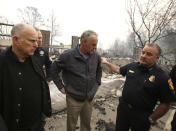 FILE - In this Wednesday, Nov. 14, 2018 file photo, Scott Upton, right, the chief of the Northern Region for the California Department of Forestry and Fire Protection briefs California Gov. Jerry Brown, Federal Emergency Management Agency Director Brock Long, second left, and U.S. Secretary of the Interior Ryan Zinke, third left, during a a tour of the fire ravaged Paradise Elementary School in Paradise, Calif. Zinke will be leaving the administration at year's end, Trump said Saturday, Dec. 15. (AP Photo/Rich Pedroncelli, File)