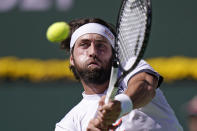 Nikoloz Basilashvili, of Georgia, returns to Stefanos Tsitsipas, of Greece, at the BNP Paribas Open tennis tournament Friday, Oct. 15, 2021, in Indian Wells, Calif. (AP Photo/Mark J. Terrill)