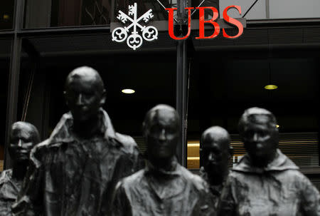 FILE PHOTO: Statues stand in front of the London office of Swiss bank UBS in London, Britain, November 20, 2012. REUTERS/Luke MacGregor/File Photo